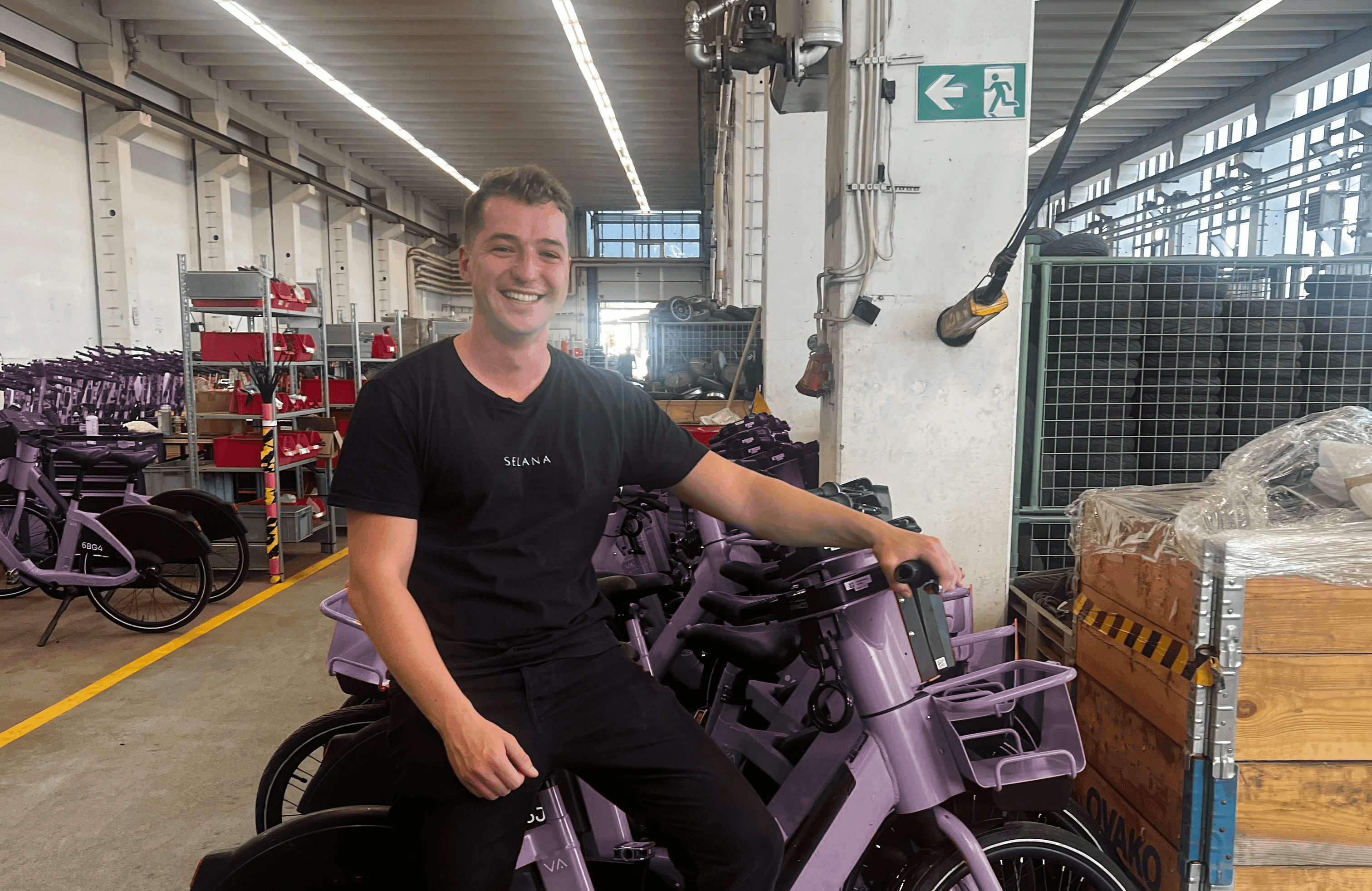 A Fleetser team member with e-bikes in the warehouse